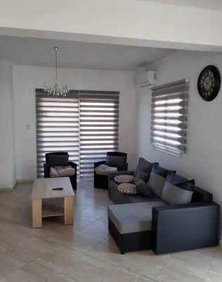 a living room with a couch and a table at KapparisVilla in Paralimni