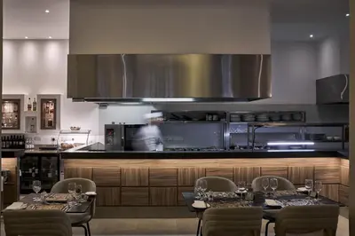 a kitchen with two tables and chairs and a kitchen with at Atlantica Sea Breeze, Adults Only in Protaras