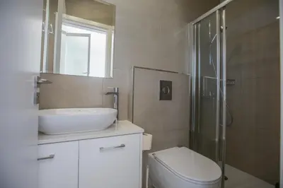 a bathroom with a sink and a toilet and a shower at Leda Villa in Protaras
