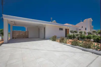 a large white house with a large driveway at Leda Villa in Protaras