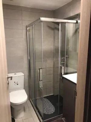 a bathroom with a shower with a toilet and a sink at To Spiti tou Faliari in Platanistasa