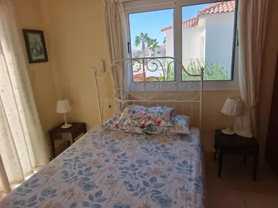 a bedroom with a bed with a window and a bedspread at Carolyn Villa is a Luxury 4-Bedroom Villa with Private Pool in Ayia Napa in Ayia Napa