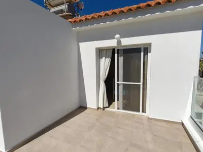 a white house with a large glass door at Carolyn Villa is a Luxury 4-Bedroom Villa with Private Pool in Ayia Napa in Ayia Napa