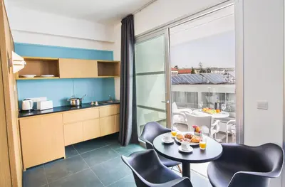 a kitchen and dining room with a table and chairs at Anthea Hotel Apartments in Ayia Napa