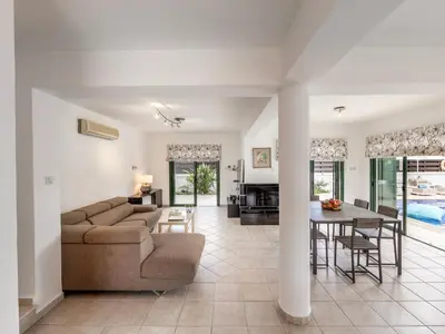 a living room with a couch and a table at Villa Eftihia in Protaras