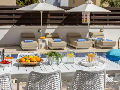 a white table with a bowl of fruit on it at Villa Eftihia in Protaras