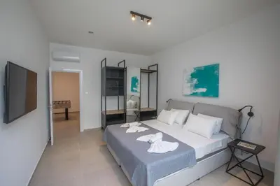 a bedroom with a bed with two towels on it at Elite Pearl Villas in Protaras