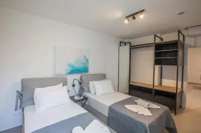 a bedroom with two beds and a bunk bed at Elite Pearl Villas in Protaras