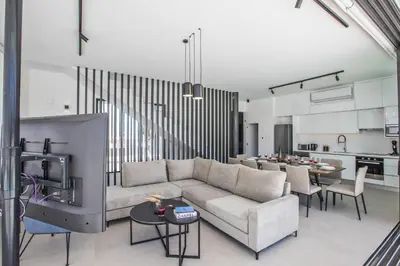a living room with a couch and a kitchen at Elite Pearl Villas in Protaras