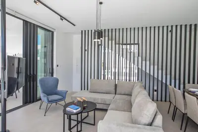 a living room with a couch and a table and chairs at Elite Pearl Villas in Protaras