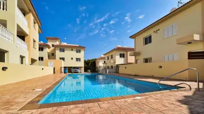 a swimming pool in the courtyard of a building at Protaras Ionian Breeze House in Paralimni