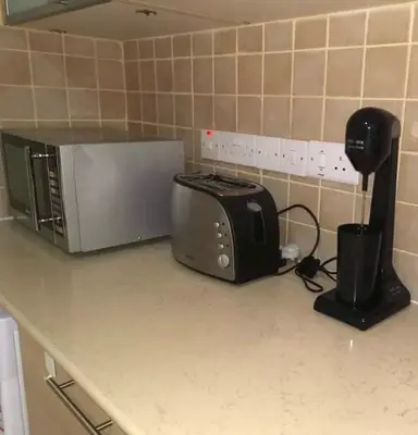 a microwave sitting on a counter in a kitchen at Protaras Ionian Breeze House in Paralimni