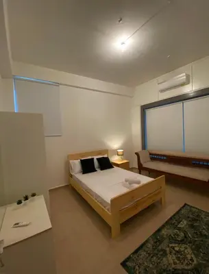a bedroom with a bed and a large window at Central Suites Down Town Nicosia in Nicosia