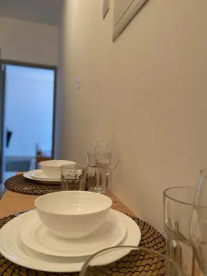 a table with plates and wine glasses on it at Central Suites Down Town Nicosia in Nicosia