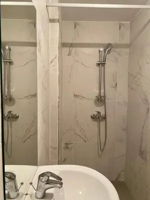 a bathroom with a sink and a shower at Central Suites Down Town Nicosia in Nicosia