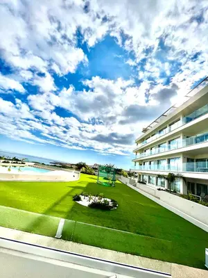 a view from the balcony of a building with a green lawn at Emerald Suites in Protaras