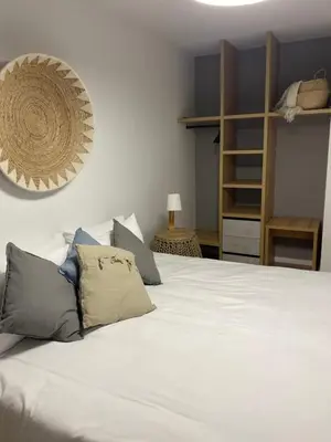 a bedroom with a large white bed with pillows at KSQUARED in Protaras