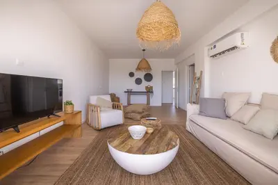a living room with a couch and a tv at KSQUARED in Protaras