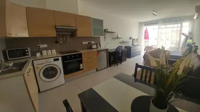 a kitchen with a washer and a washing machine at Pyla Gardens A202 Studio in Pyla