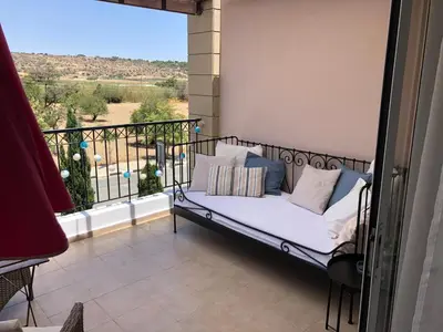 a bed on a balcony with a view at Pyla Gardens A202 Studio in Pyla