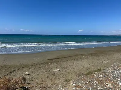 an empty beach with the ocean in the background at Mersey Faros Complex in Pervolia