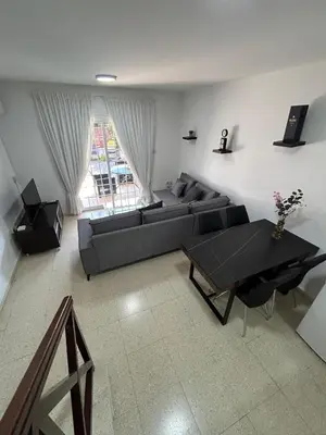 a living room with a couch and a table at Mersey Faros Complex in Pervolia