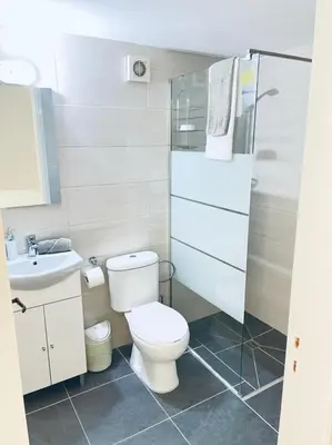 a bathroom with a toilet and a sink at Mersey Faros Complex in Pervolia