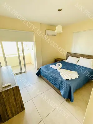 a bedroom with a bed with a towel on it at Milos City Center Apts No.34 in Larnaka