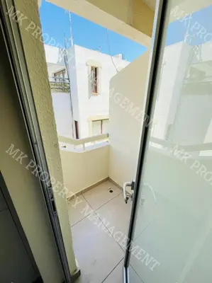 a room with a view from the glass door of a balcony at Milos City Center Apts No.34 in Larnaka