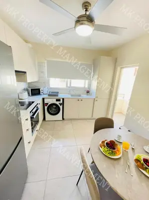 a kitchen with a table with a plate of food on it at Milos City Center Apts No.34 in Larnaka