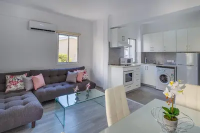 a living room with a couch and a table at Downtown Larnaca in Larnaka