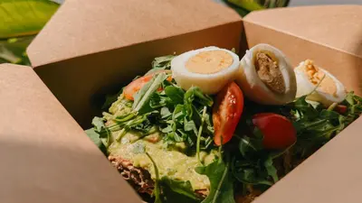 a box filled with a salad with a hard boiled egg at Alinea Urban Saripolou Square in Limassol