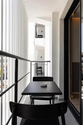 a black table and chairs on a balcony at Alinea Urban Saripolou Square in Limassol