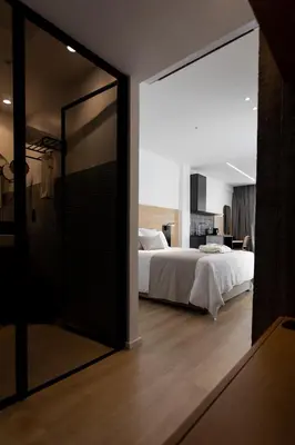 a bedroom with a bed and a large mirror at Alinea Urban Saripolou Square in Limassol