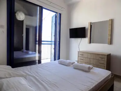 a bedroom with a large bed with two towels on it at Olive Tree Villa - Protaras in Protaras