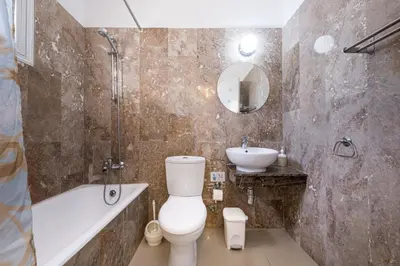 a bathroom with a toilet and a sink at Anais Bay Hotel in Protaras