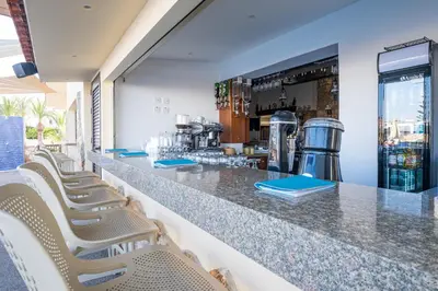 a bar with a row of chairs at a restaurant at Anais Bay Hotel in Protaras