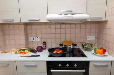 a kitchen counter with a stove with vegetables on it at Mylos 9 in Protaras