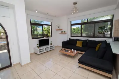 a living room with a couch and a tv at Mylos 9 in Protaras