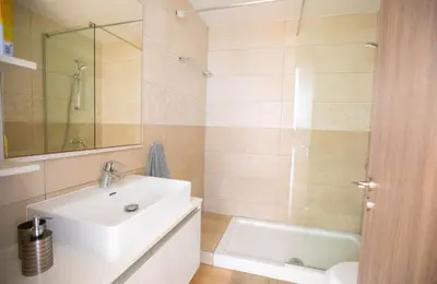 a bathroom with a white sink and a shower at Panayia Sea View Apts in Protaras