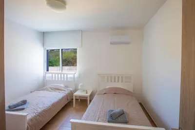 a bedroom with two beds and a window at Panayia Sea View Apts in Protaras
