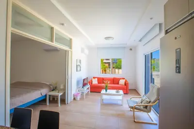 a living room with a red couch in a room at Panayia Sea View Apts in Protaras