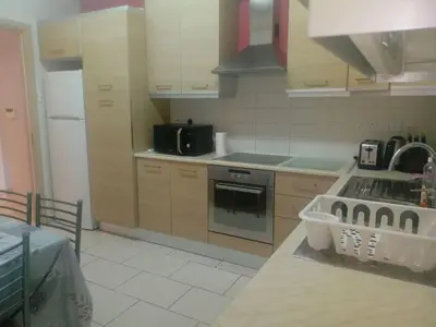 a kitchen with a sink and a stove top oven at Apartment Sleeps 6 with Ensuite in Nicosia