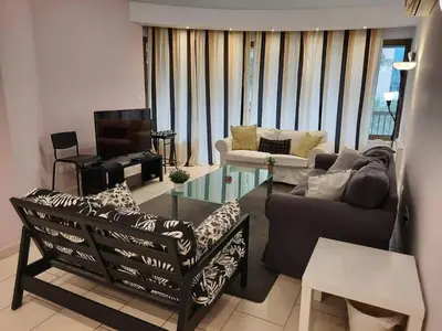 a living room with a couch and a tv at Apartment Sleeps 6 with Ensuite in Nicosia