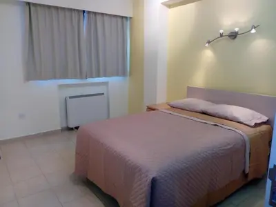 a bedroom with a bed and a window at Apartment Sleeps 6 with Ensuite in Nicosia