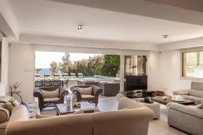 a living room with a couch and a table and a television at Villa Adalia in Protaras
