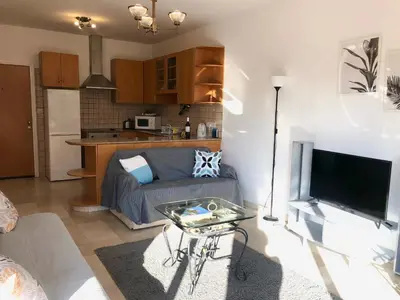 a living room with a couch and a tv at 1 bedroom flat, prime location near sea, sleeps 4 in Limassol