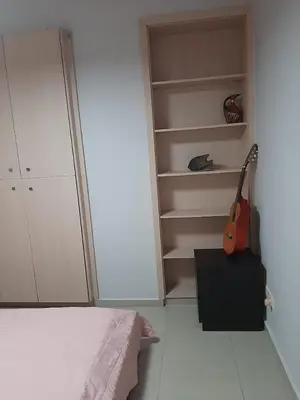 a bedroom with a guitar in a closet at Universe House in Mor Menekshe
