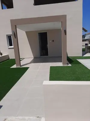 a large white building with a yard with green grass at Universe House in Mor Menekshe