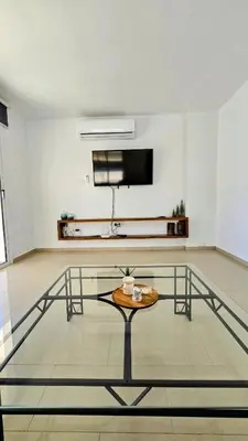 a living room with a table and a flat screen tv at Sweet Destiny Villa with private pool in Ayia Napa
